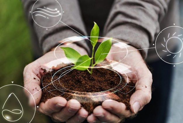 Smart agriculture IoT with hand planting tree background