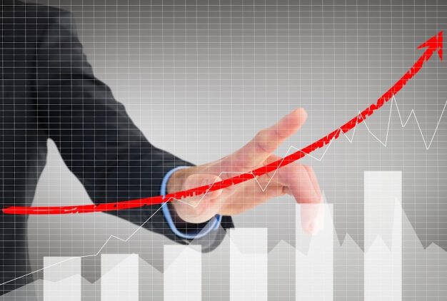 composite of businessman pointing at rising graph